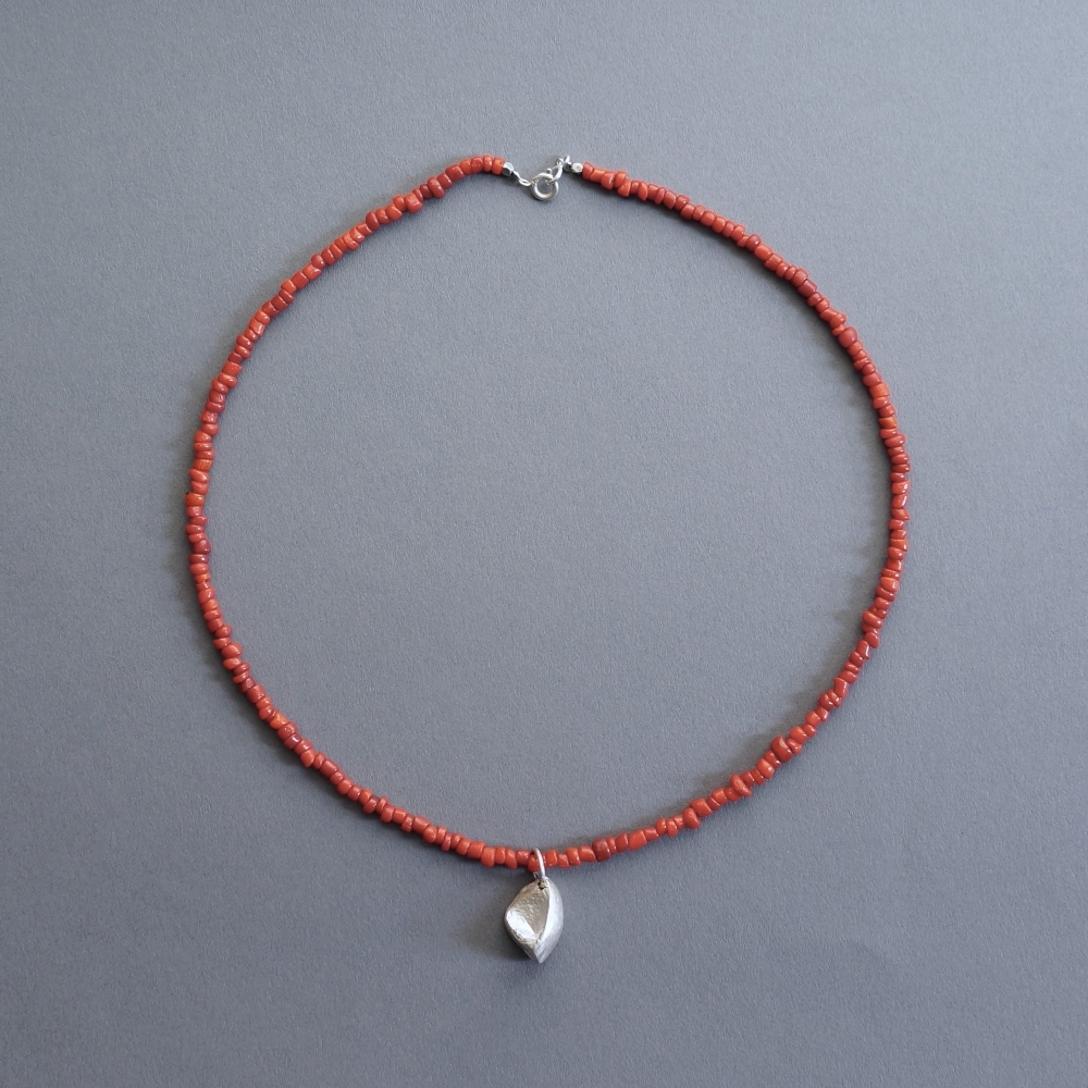 Melanie Decourcey/Beaded Necklace/Nepalese coral necklace with silver beechnut pendant