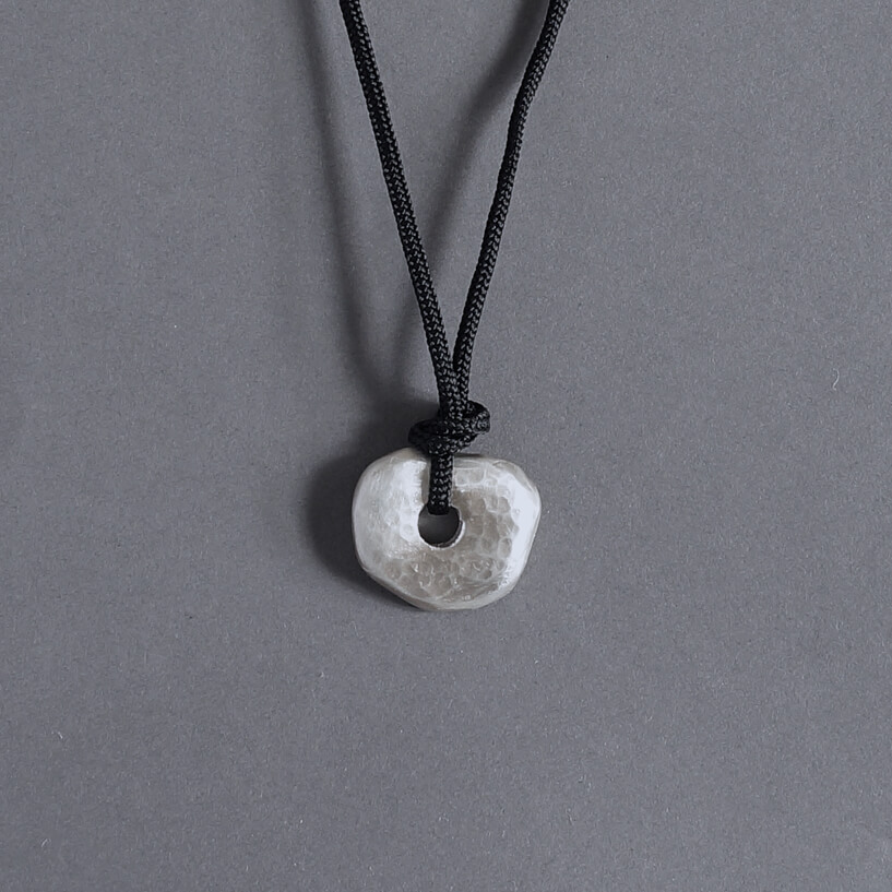 Melanie Decourcey / pendant on string / medium silver hammerd disc pendant