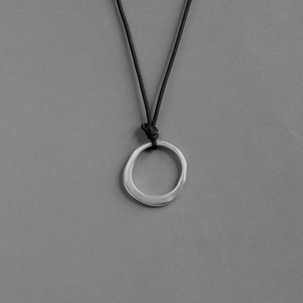 Melanie Decourcey / pendant on string / freestyle circle silver pendant