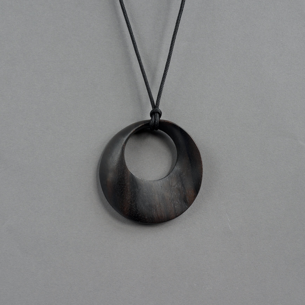 Melanie Decourcey / round ebony wood pendant on string