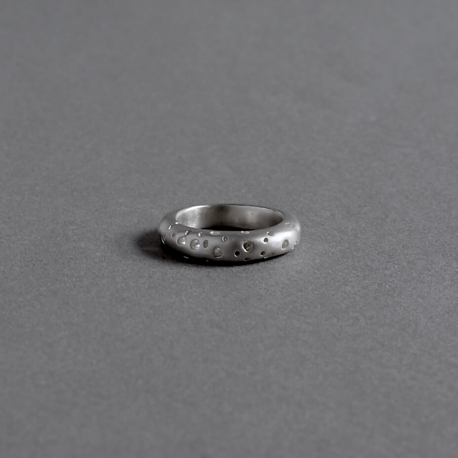 Melanie Decourcey / thick silver ring with hole pattern